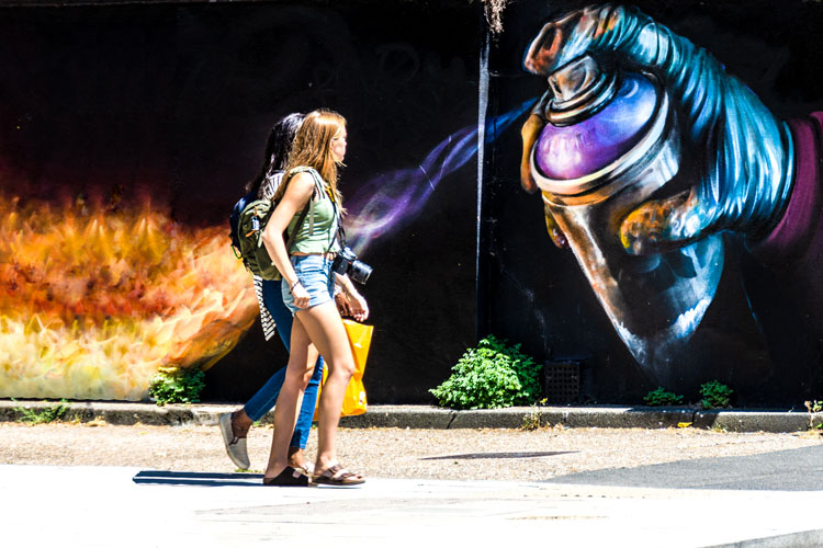 She's on fire - girls walking in front of image of sprayed fire